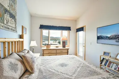 a bedroom with a bed and a window at Lake Forest Summit Condo: Great Penthouse Views in Frisco