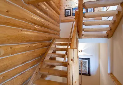 a staircase in a log cabin with wooden walls at Elk Meadow Lodge: Luxury Log Home, Hot Tub in Breckenridge