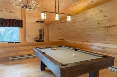 a pool table in a room with wooden walls at Elk Meadow Lodge: Luxury Log Home, Hot Tub in Breckenridge