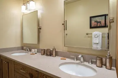 a bathroom with two sinks and a large mirror at Elk Meadow Lodge: Luxury Log Home, Hot Tub in Breckenridge