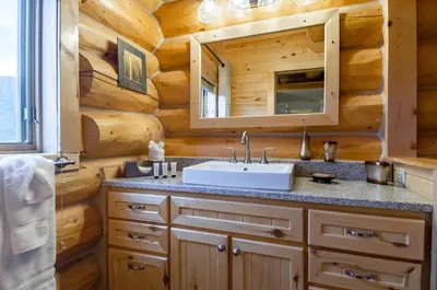 a bathroom with a sink in a log cabin at Elk Meadow Lodge: Luxury Log Home, Hot Tub in Breckenridge