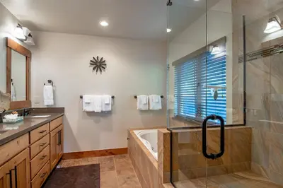 a bathroom with a shower and a tub and a sink at Frisco Sports Chalet Tenmile Condo: Stylish, On Shuttle Route in Frisco