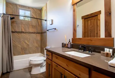 a bathroom with a sink and a toilet and a shower at Frisco Sports Chalet Tenmile Condo: Stylish, On Shuttle Route in Frisco