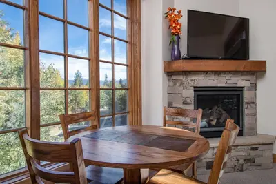 a dining room with a table and a fireplace at Frisco Sports Chalet Tenmile Condo: Stylish, On Shuttle Route in Frisco