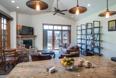 a living room with a table with a bowl of fruit on it at Frisco Sports Chalet Tenmile Condo: Stylish, On Shuttle Route in Frisco