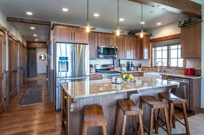 a kitchen with a large island with bar stools at Frisco Sports Chalet Tenmile Condo: Stylish, On Shuttle Route in Frisco