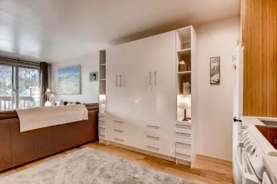 a bedroom with white cabinets and a bed and a window at Cedar Lodge Peak One Studio Condo: Downtown Frisco in Frisco