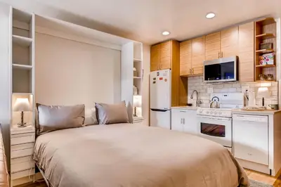 a bedroom with a large bed and a kitchen at Cedar Lodge Peak One Studio Condo: Downtown Frisco in Frisco