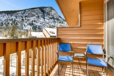two chairs on a balcony with a view of a mountain at Cedar Lodge Peak One Studio Condo: Downtown Frisco in Frisco