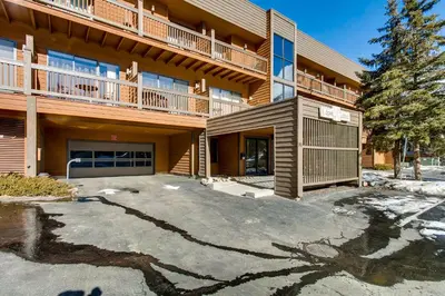 an apartment building with a parking lot in front of it at Cedar Lodge Peak One Studio Condo: Downtown Frisco in Frisco