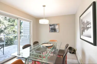 a dining room with a glass table and chairs at River Glen Brookside Condo: Fantastic Frisco Location in Frisco
