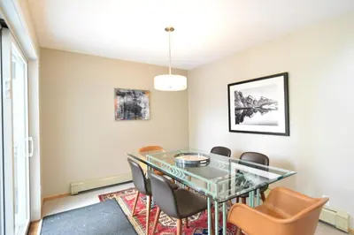 a dining room with a glass table and chairs at River Glen Brookside Condo: Fantastic Frisco Location in Frisco