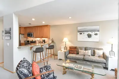 a living room with a couch and a table at River Glen Brookside Condo: Fantastic Frisco Location in Frisco