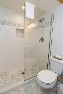 a bathroom with a toilet and a glass shower at Mountainside Peakview Condo: Cool Location, Updates in Frisco