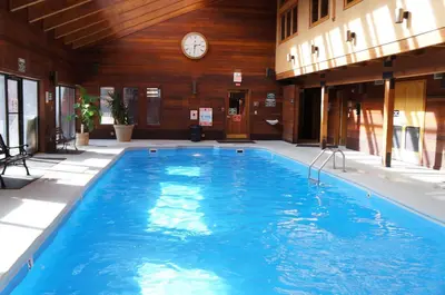 a swimming pool in a building with a clock on the wall at Mountainside Peakview Condo: Cool Location, Updates in Frisco