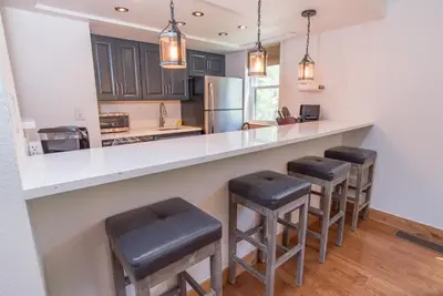 a kitchen with a counter with stools in it at Mountainside Peakview Condo: Cool Location, Updates in Frisco