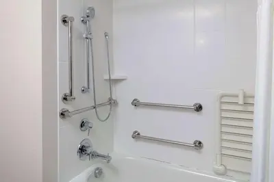 a bathroom with a bath tub with towel bars at Hilton Garden Inn Denver/Thornton in Thornton