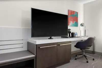 a desk with a television on top of it at Hilton Garden Inn Denver/Thornton in Thornton