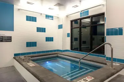 a swimming pool in a building with blue and white walls at Hilton Garden Inn Denver/Thornton in Thornton