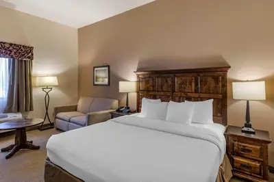 a hotel room with a bed and a couch at Best Western Brighton Inn in Brighton