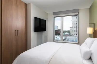 a bedroom with a large white bed and a window at Element Denver Downtown East in Denver