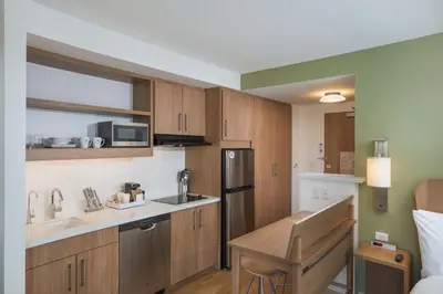 a small kitchen with a sink and a refrigerator at Element Denver Downtown East in Denver