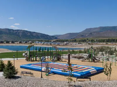 a playground with a blue slide in a park at Sun Outdoors Rocky Mountains in Granby