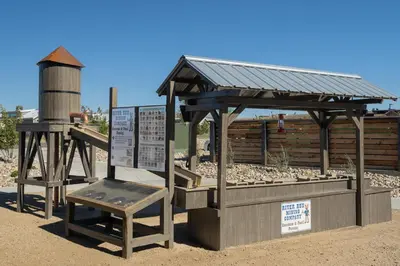 a wooden shelter with a chair and a water tower at Sun Outdoors Rocky Mountains in Granby