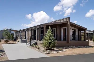 a small building with a tree in front of it at Sun Outdoors Rocky Mountains in Granby