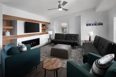 a living room with couches and a fireplace at Sun Outdoors Rocky Mountains in Granby