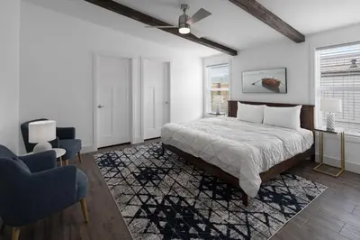 a bedroom with a bed and two chairs at Sun Outdoors Rocky Mountains in Granby