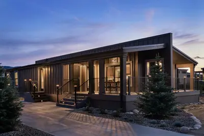 a house with a christmas tree in front of it at Sun Outdoors Rocky Mountains in Granby