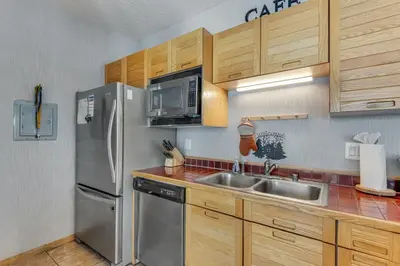 a kitchen with a stainless steel refrigerator and a sink at Timber Ridge Retreat in Silverthorne
