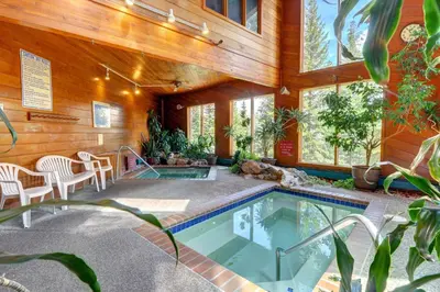a house with a swimming pool in the middle of it at Timber Ridge Retreat in Silverthorne