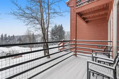 a balcony of a house with snow on it at Timber Ridge Retreat in Silverthorne