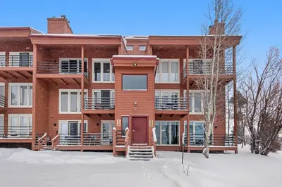 an apartment building with snow in front of it at Timber Ridge Retreat in Silverthorne