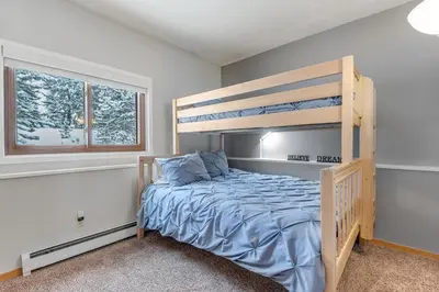 a bedroom with a bunk bed and a window at Timber Ridge Retreat in Silverthorne