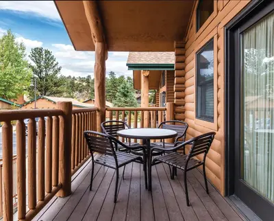 a patio with a table and chairs on a deck at WorldMark Estes Park in Estes Park