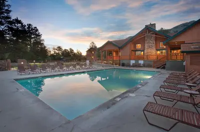a large swimming pool with chairs and a house at WorldMark Estes Park in Estes Park