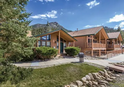 a log home with a mountain in the background at WorldMark Estes Park in Estes Park