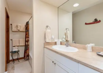 a bathroom with a sink and a mirror at Herondale Luxury Home Home in Estes Park
