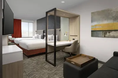 a hotel room with a bed and a desk at SpringHill Suites by Marriott Loveland Fort Collins/Windsor in Windsor
