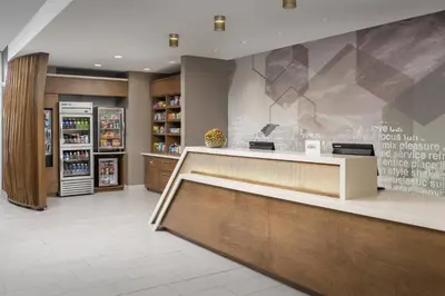 a store lobby with a counter and a refrigerator at SpringHill Suites by Marriott Loveland Fort Collins/Windsor in Windsor
