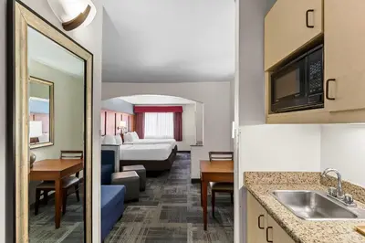 a hotel room with a bed and a living room at Comfort Suites Denver Tech Center in Centennial