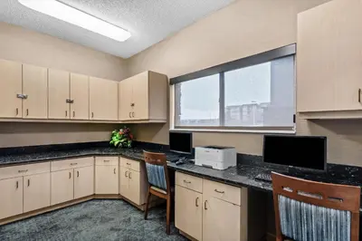 an office with a desk with chairs and a window at Comfort Suites Denver Tech Center in Centennial