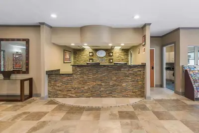 a lobby with a brick wall and a counter at Comfort Suites Denver Tech Center in Centennial