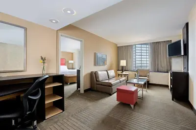 a hotel room with a bed and a living room at Holiday Inn Express Denver Downtown by IHG in Denver