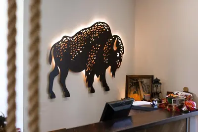 a wooden animal on a wall next to a desk at Basecamp Boulder in Boulder