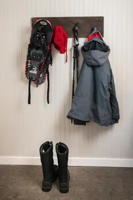 a pair of boots and a snowboard hanging on a wall at Basecamp Boulder in Boulder