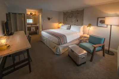 a hotel room with a bed and a desk and a chair at Basecamp Boulder in Boulder